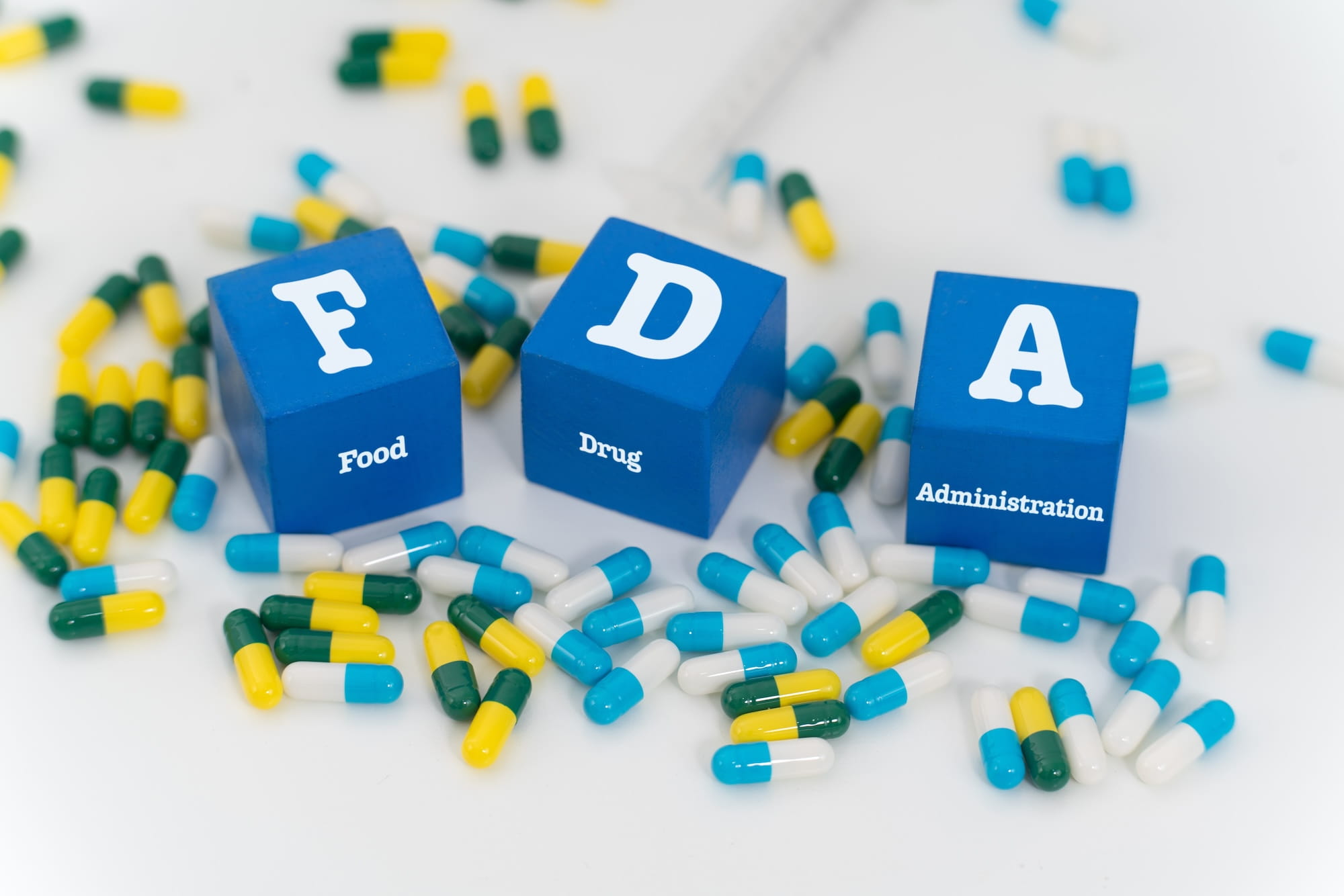 FDA food drug administration cubes surrounded by prescription capsules